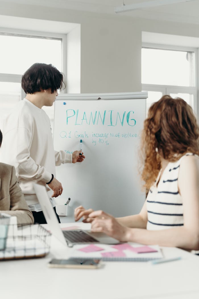 Professional colleagues brainstorming and planning during a business meeting in a modern office setting.