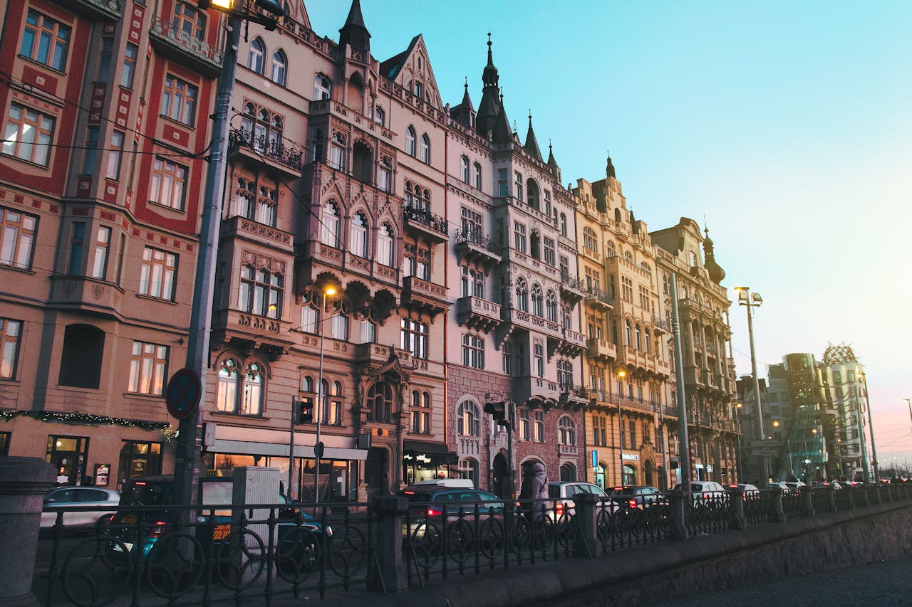 Historic Prague street with classic architecture bathed in sunset glow, highlighting its urban charm.