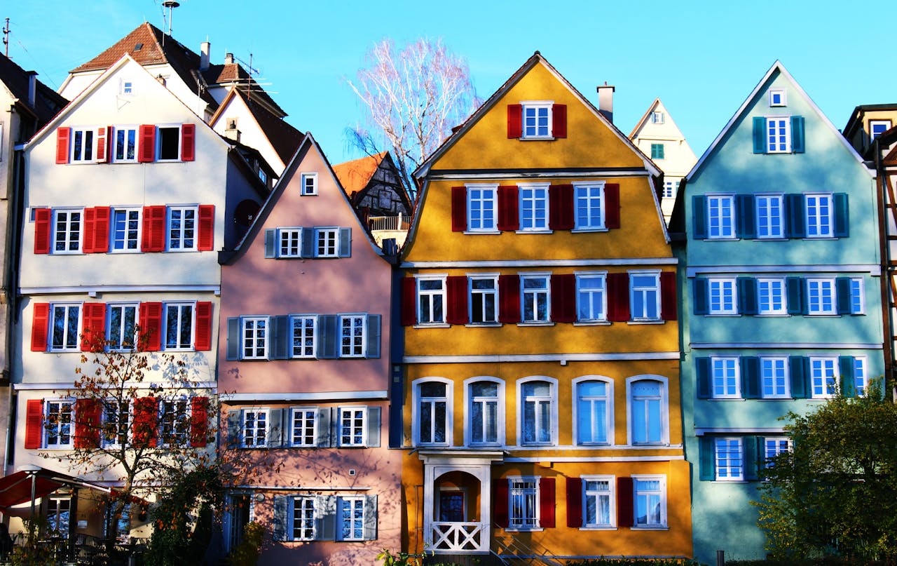 Vibrant facades of traditional houses in Tübingens historic center, under a clear daytime sky.